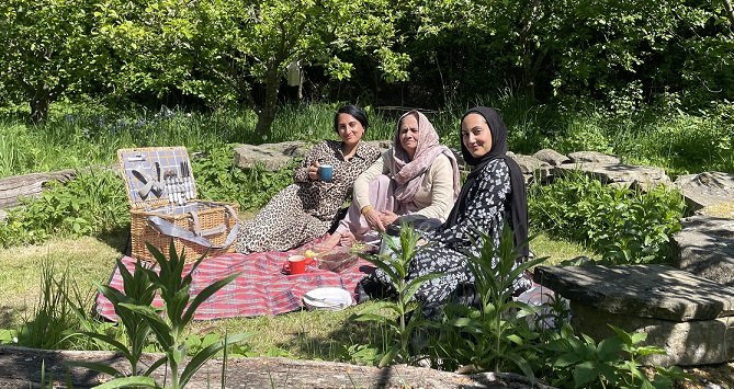 three women enjoying a picnic in the sunshine