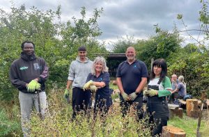 group of volunteers working to build benches in an orchard