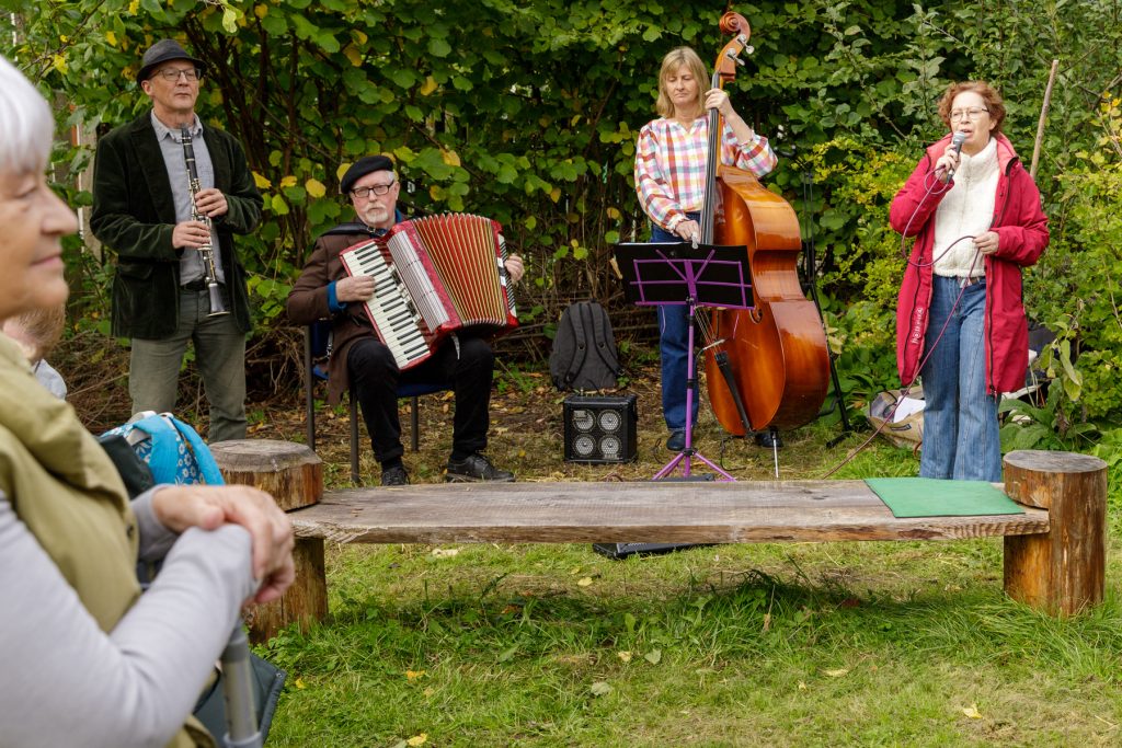 band playing an accordion and double bass among trees