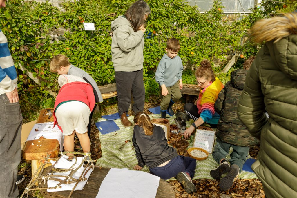 nature arts with adults and children in a sunny orchard.